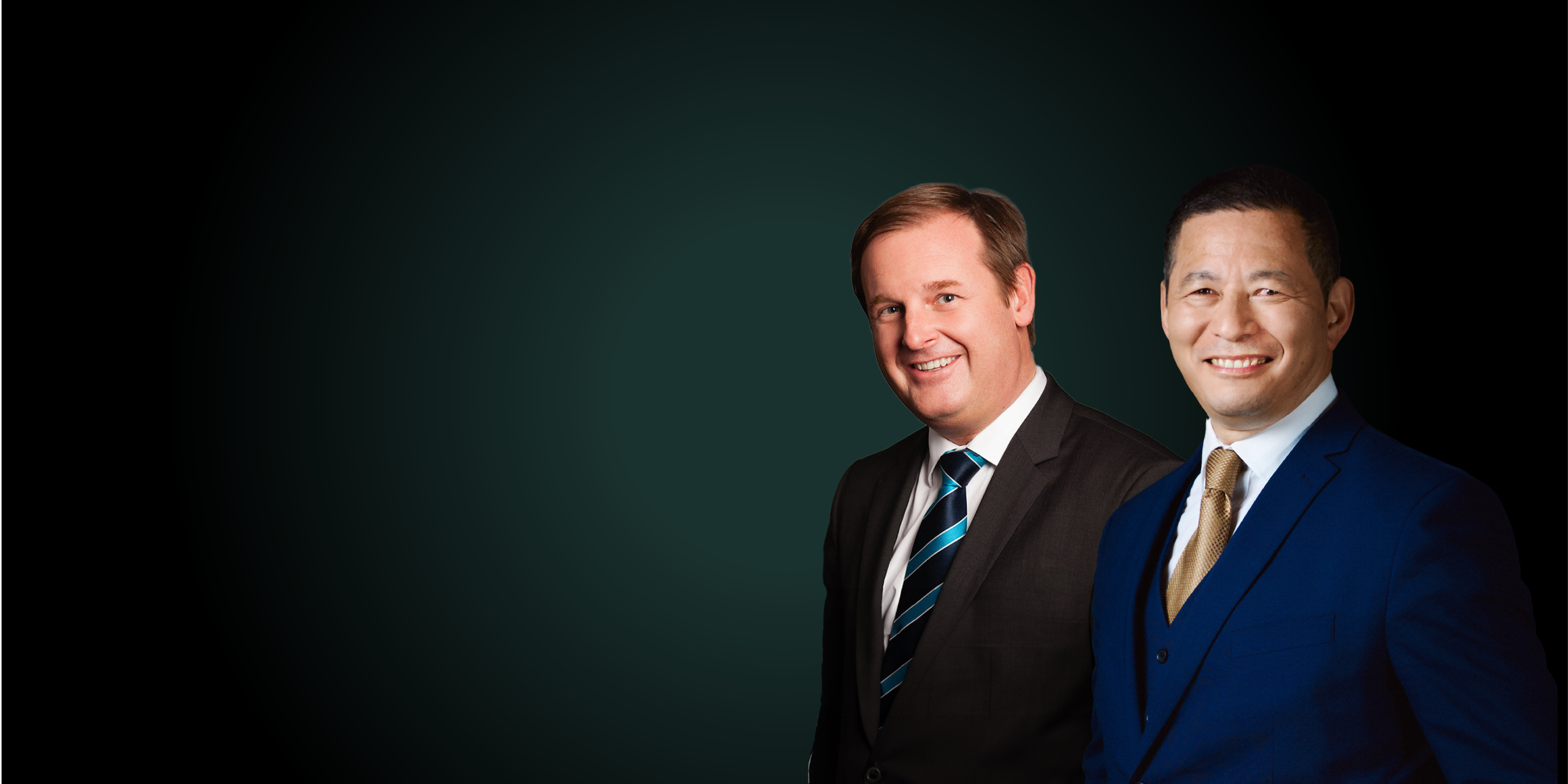 Two men dressed in a blue suit, smiling